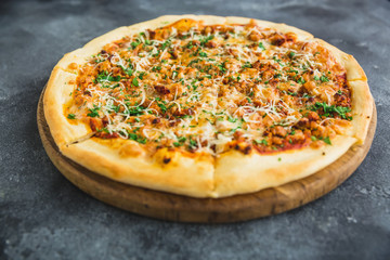 Italian pizza with bacon, cheese and tomato. Close up view.