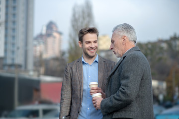 Young businessman and his mature mentor having a conversation