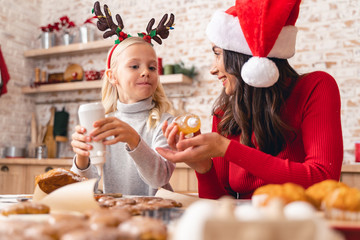 Cheerful young woman looking at her daughter