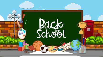 Back to school sign with many school items in background
