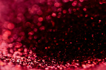 red Sparkling Lights Festive background with texture. Abstract Christmas twinkled bright bokeh defocused and Falling stars. Winter Card or invitation	