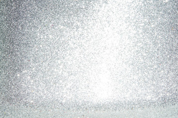 Silver Sparkling Lights Festive background with texture. Abstract Christmas twinkled bright bokeh defocused and Falling stars. Winter Card or invitation	