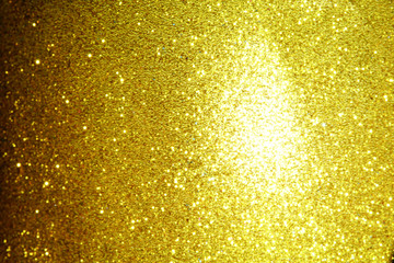 gold Sparkling Lights Festive background with texture. Abstract Christmas twinkled bright bokeh defocused and Falling stars. Winter Card or invitation	