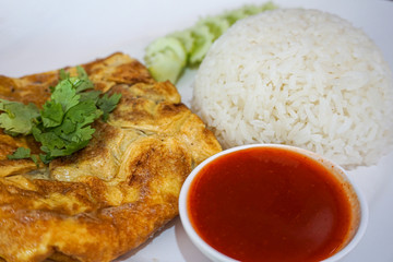 Close up omlet with rice and chilli sauce