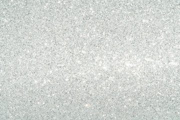 Obraz premium Silver Sparkling Lights Festive background with texture. Abstract Christmas twinkled bright bokeh defocused and Falling stars. Winter Card or invitation 