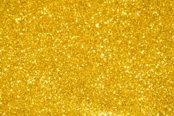 gold Sparkling Lights Festive background with texture. Abstract Christmas twinkled bright bokeh defocused and Falling stars. Winter Card or invitation	