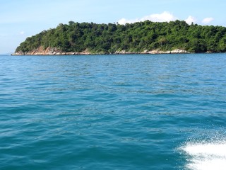 Travel to Thailand. The view from the board of the speed boat to the island was given. The blue water of the Andaman Sea.