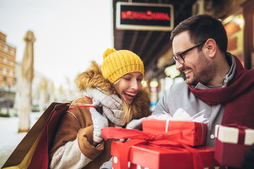 Young couple doing Christmas shopping in the city