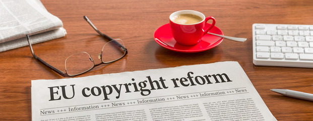 A newspaper on a wooden desk -EU copyright reform
