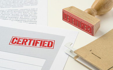 A red stamp on a document - Certified