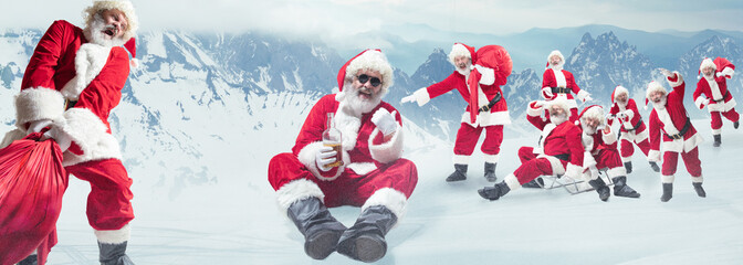 Emotional Santa Clauses greeting with New Year 2020 and Christmas. Men in traditional costume laughting, drinking alcohol, carrying a bag with mountain on background. Winter, holidays. Copyspace.