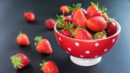 strawberries in a colorful bowl on a colorful background