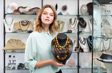 Female demonstrating amber necklace