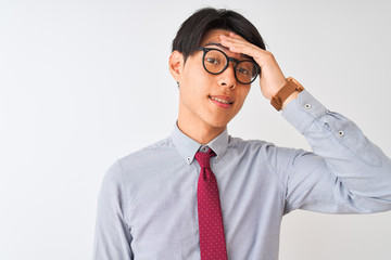 Chinese businessman wearing tie and glasses standing over isolated white background stressed with hand on head, shocked with shame and surprise face, angry and frustrated. Fear and upset for mistake.
