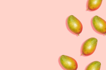 Ripe mango pattern on a pink background with copy space