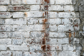 Texture of old white brick wall. Dirty facade of ancient building. Urban background.
