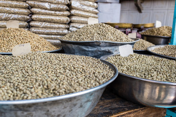Green unroasted coffee beans for sale in a market