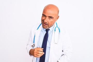 Fototapeta premium Middle age doctor man wearing stethoscope and tie standing over isolated white background winking looking at the camera with sexy expression, cheerful and happy face.