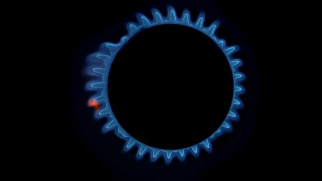 Top down view of gas stove is switching on. Burning gas, gas stove burner. Black dark background. Slow motion