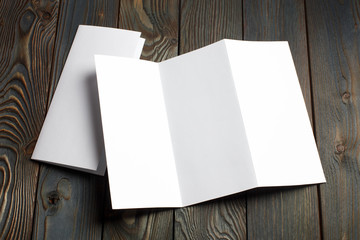 Folded sheets of white paper on dark wooden background