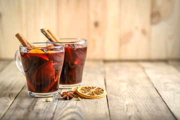 Mulled wine in glasses with apples, orange, cinnamon and star anise. Hot Christmas drink on a...