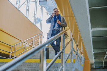 Attractive stylish man talking on cellphone and smiling