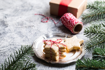Christmas background. festive gingerbread cookie with ribbon, pine branches and Christmas decorations