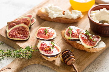 ciabatta or bruschetta with cottage cheese, figs and honey. sandwich with figs and goat cheese