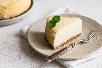 Slice Of Classical New York Cheesecake On White Plate. Closeup View. Home bakery concept