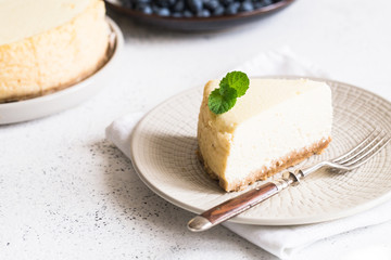 Slice Of Classical New York Cheesecake On White Plate. Closeup View. Home bakery concept