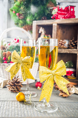 Two champagne glasses with christmas decoration on wooden snow background. Happy New Year and  christmas Celebration.