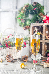 Two champagne glasses with christmas decoration on wooden snow background. Happy New Year and  christmas Celebration.