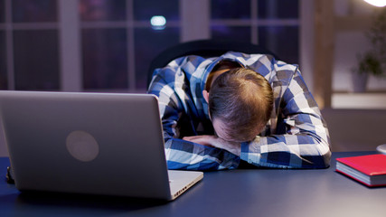 Caucasian businessman sleeping with his head on the office