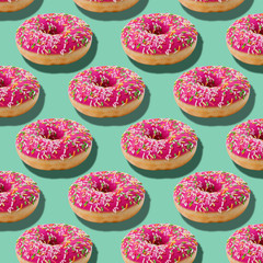 Bright food seamless isometric pattern with donuts.Pink glazed donuts with colorful sugar sprinkles on blue turquoise background.Minimal abstract creative concept.Photography collage