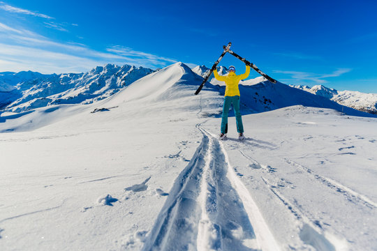 Woman with ski in high mountains.
