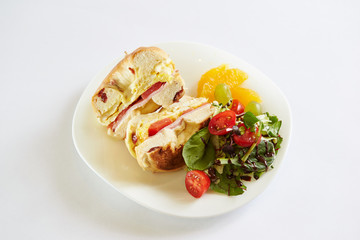 Bagel sandwich and salad on plate