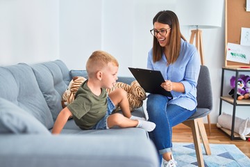 Young therapist woman speaking with child, counselor and behaviour correction at the office around toys