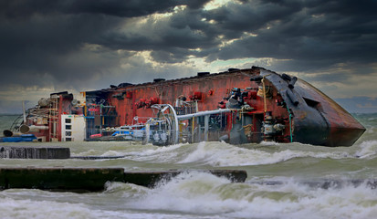 After a severe storm, the tanker was shipwrecked on the popular beach of Odessa, Ukraine. The ship lies on its side directly on the breakwater. Close-up dramatic photo. - obrazy, fototapety, plakaty
