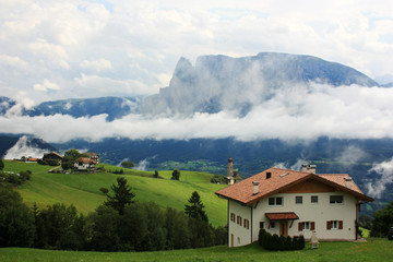 Alpine houses on the slopes of the Dolomites