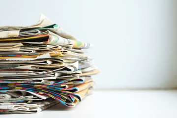 Newspapers with Headlines and Articles. News Pages Stacked in Pile. Business Concept with Copy Space