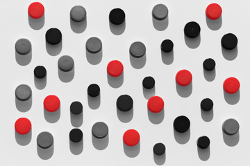 Plastic bottle caps background with black and red color random pattern on white background