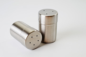 Metal containers with holes in the lids for salt and pepper, for serving the kitchen table