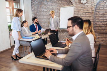 Group of young business people working together in creative office.