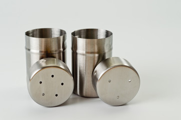 Metal containers with holes in the lids for salt and pepper, for serving the kitchen table