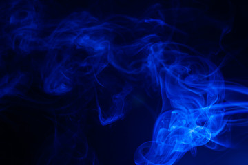 Blue smoke on black background.