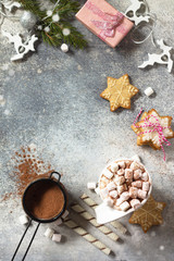 Christmas dessert or breakfast. A cup of hot cocoa with marshmallows and Christmas baking on a stone countertop. Top view on a flat background. Copy space.