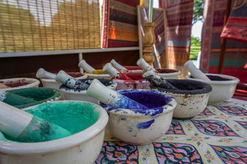 Dried watercolors in small porcelain mortars