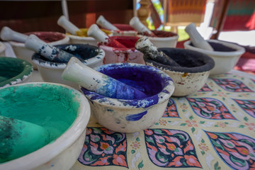 Dried watercolors in small porcelain mortars