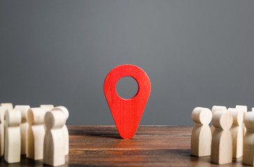 Two groups of people are divided by a red location indicator. Meeting place concept. acquaintance via the Internet. Event or holiday. joint trip. Attractive popular place, tourist magnet.
