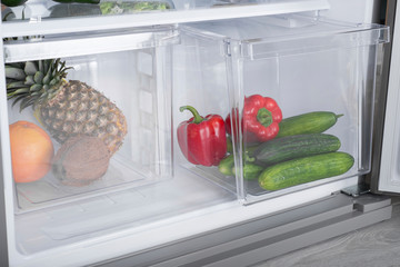 Open fridge full of fresh fruits and vegetables